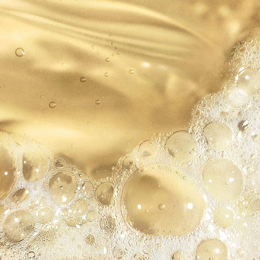Close-up of gold bubbles and liquid surface
